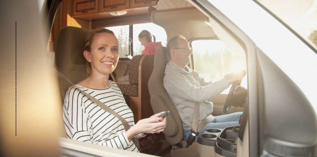 A family driving in a Class C RV on vacation together